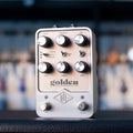 Silver guitar effects pedal with multiple knobs, toggle switches, and two foot switches, labeled 'golden reverberator'.