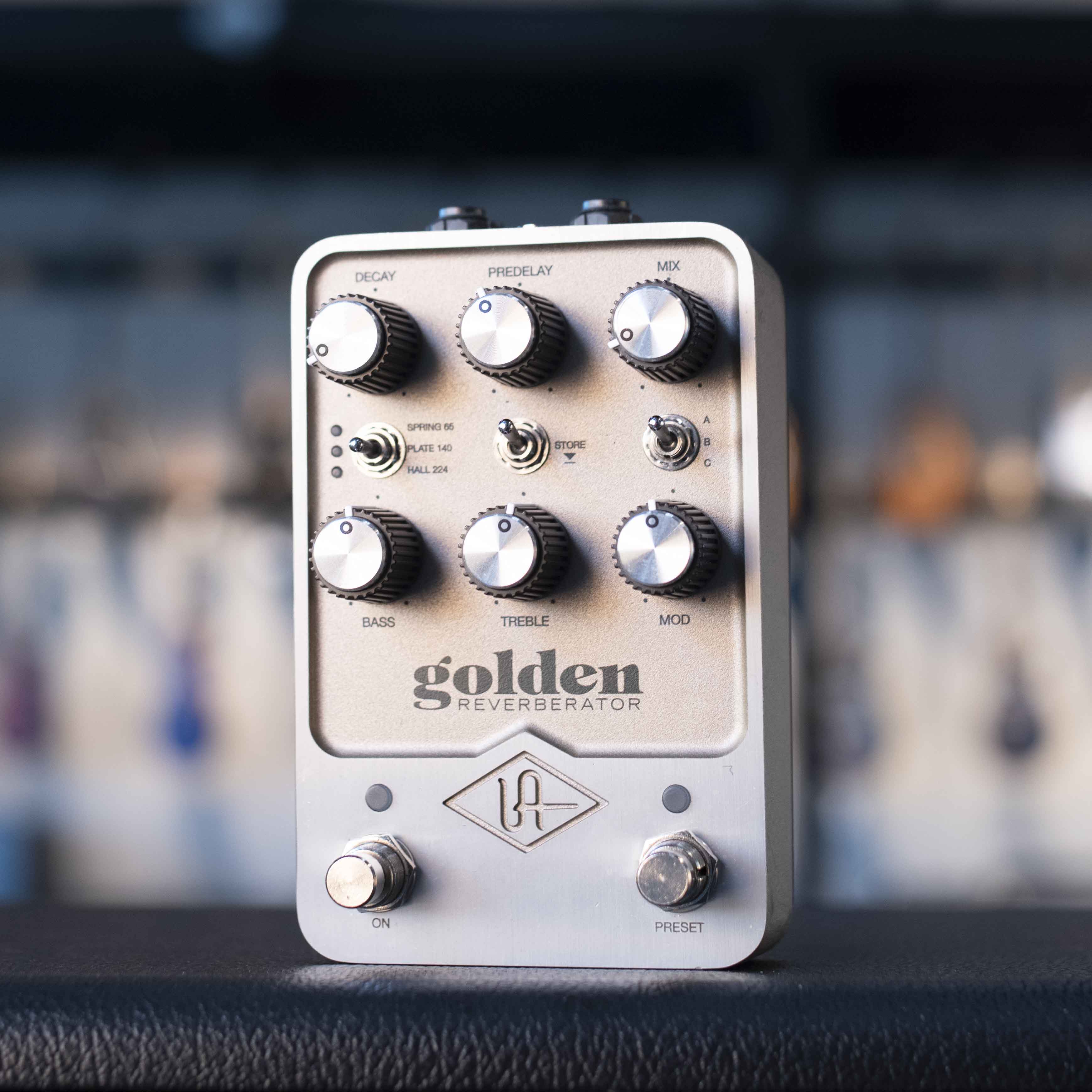 Silver guitar effects pedal with multiple knobs, toggle switches, and two foot switches, labeled 'golden reverberator'.