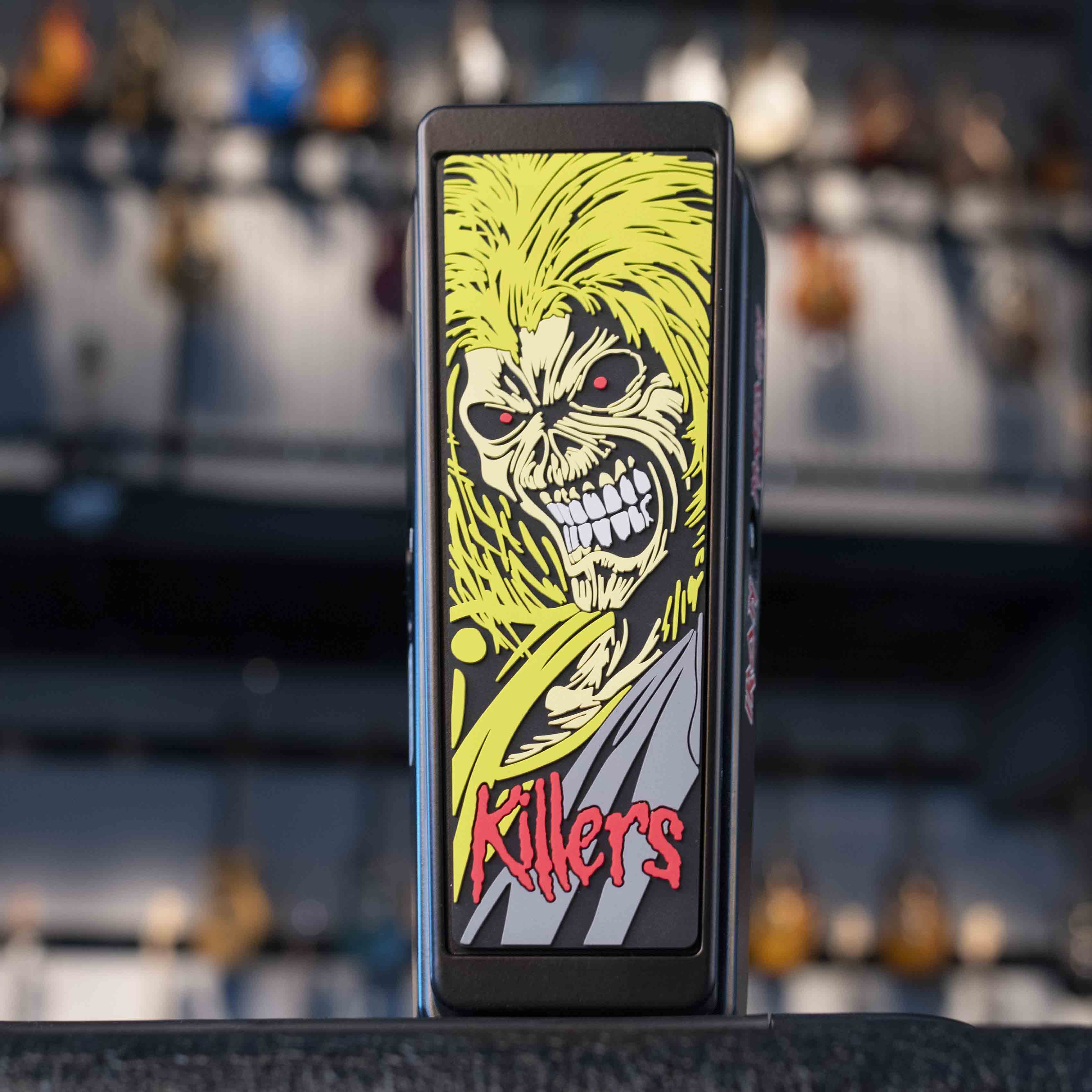 Front view of a guitar wah pedal with graphic art of a skull-faced character and red text reading Killers.