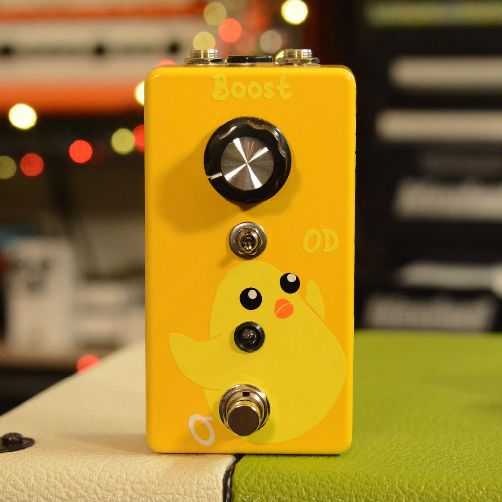 Yellow guitar effects pedal with a large knob, toggle switch, footswitch, and a cartoon chick graphic on front.