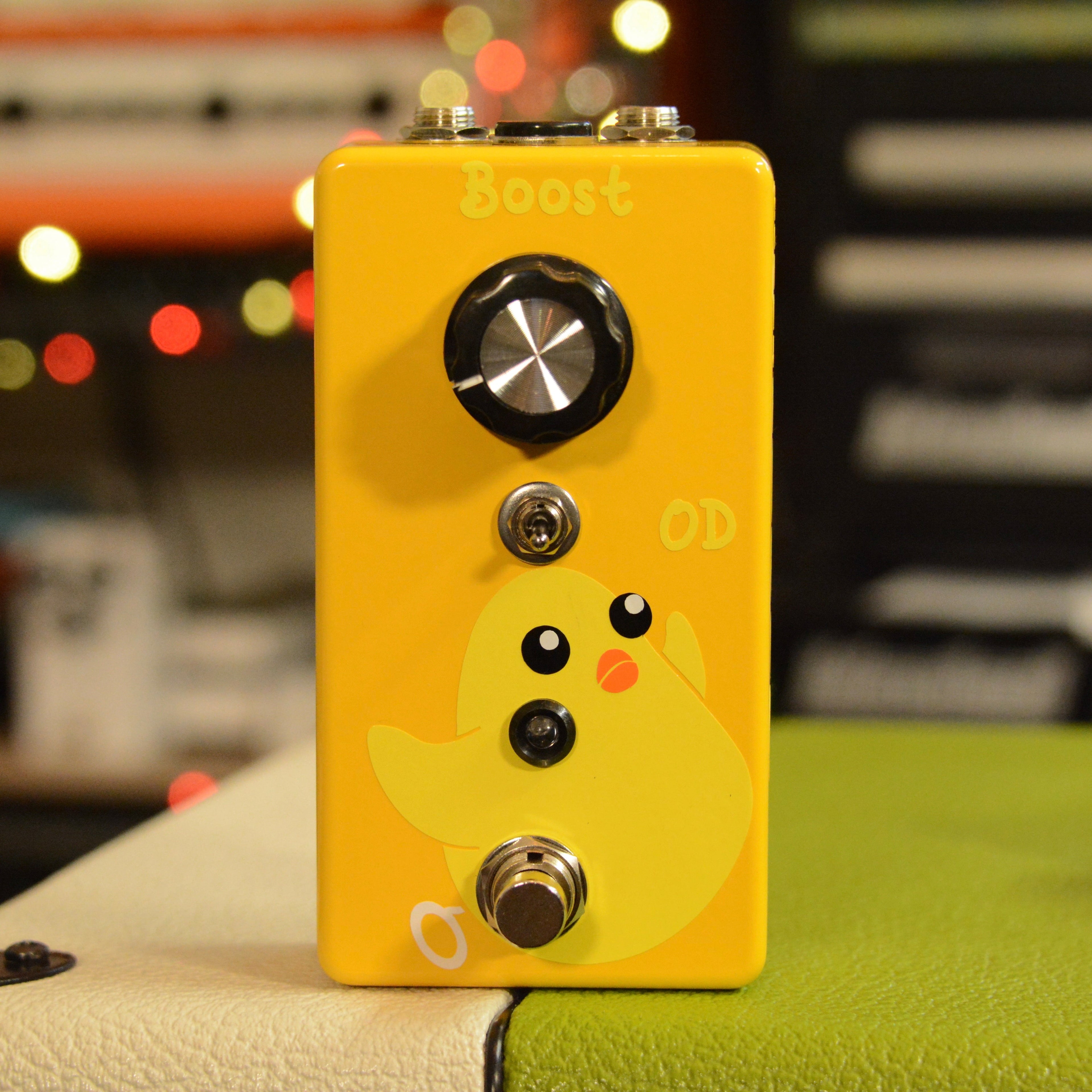 Yellow guitar effects pedal with a large knob, toggle switch, footswitch, and a cartoon chick graphic on front.
