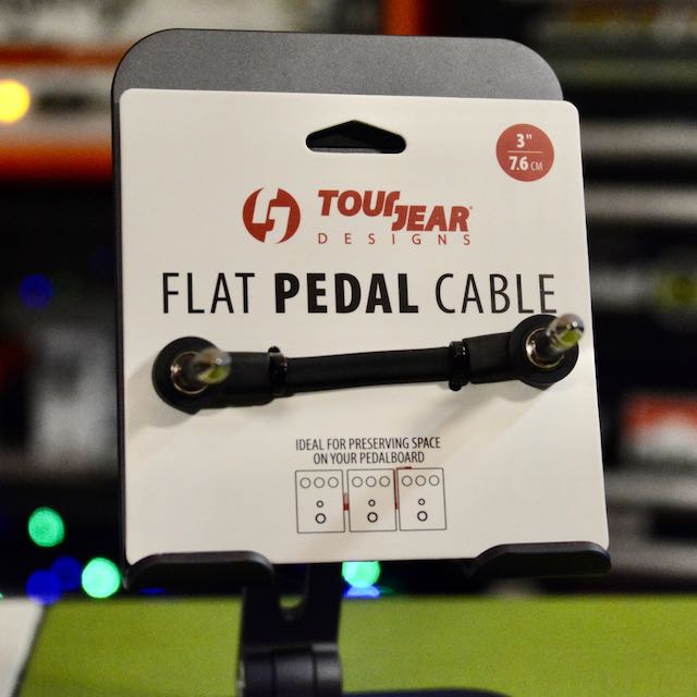 Black flat patch cable with right-angle and straight 1/4 inch plugs on display card from Tough Gear Designs.
