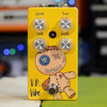 Yellow guitar effects pedal with four knobs labeled Speed, Tone, Level, Depth and a footswitch, featuring a stitched doll graphic.