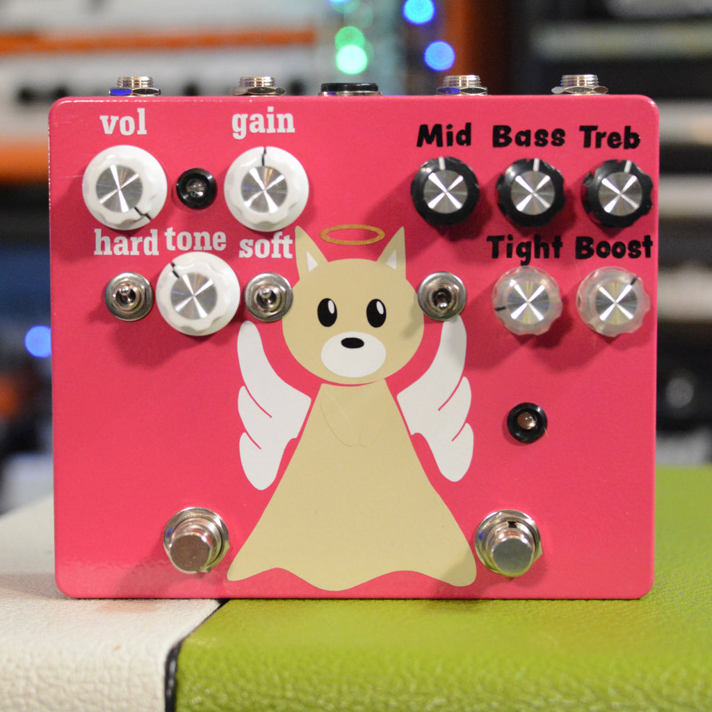 Pink guitar effects pedal with knobs, toggle switches, footswitches, and a cartoon angel dog graphic.