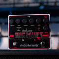 Electro-Harmonix Deluxe Big Muff guitar effects pedal with six knobs, two footswitches, and toggle switches on black panel.
