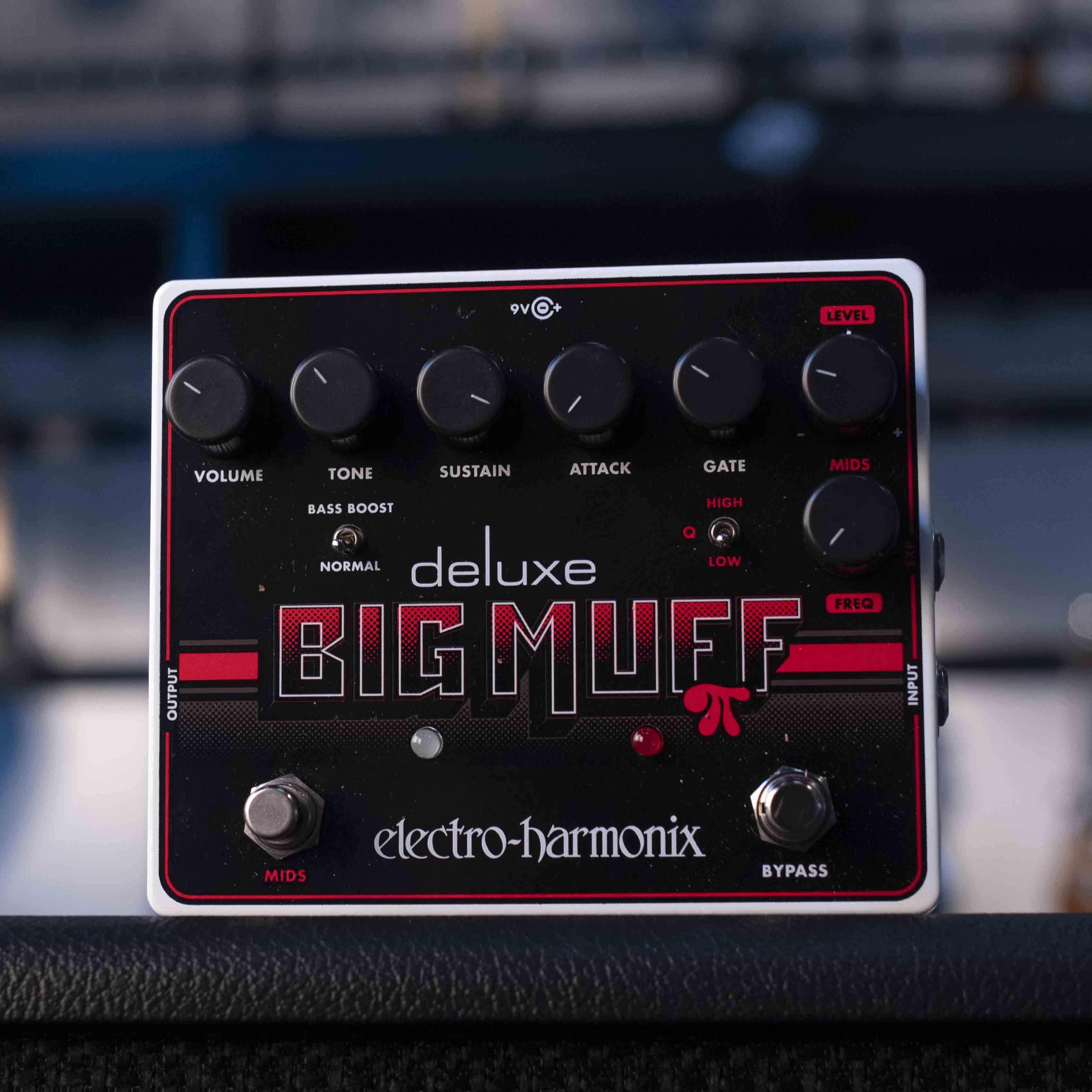 Electro-Harmonix Deluxe Big Muff guitar effects pedal with six knobs, two footswitches, and toggle switches on black panel.
