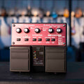 Black and red BOSS RC-20XL loop station pedal with knobs, buttons, and dual footswitches on a black surface.