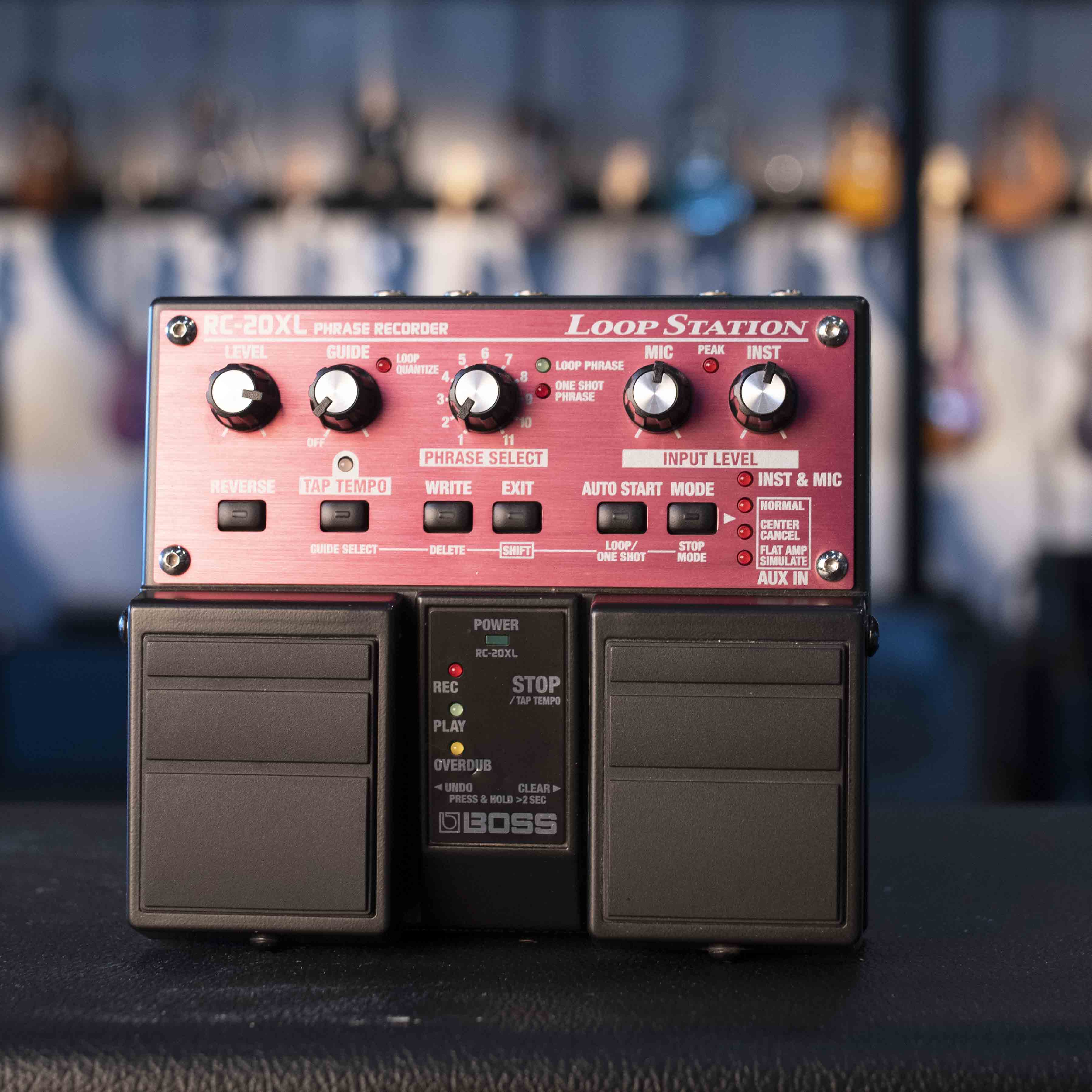 Black and red BOSS RC-20XL loop station pedal with knobs, buttons, and dual footswitches on a black surface.