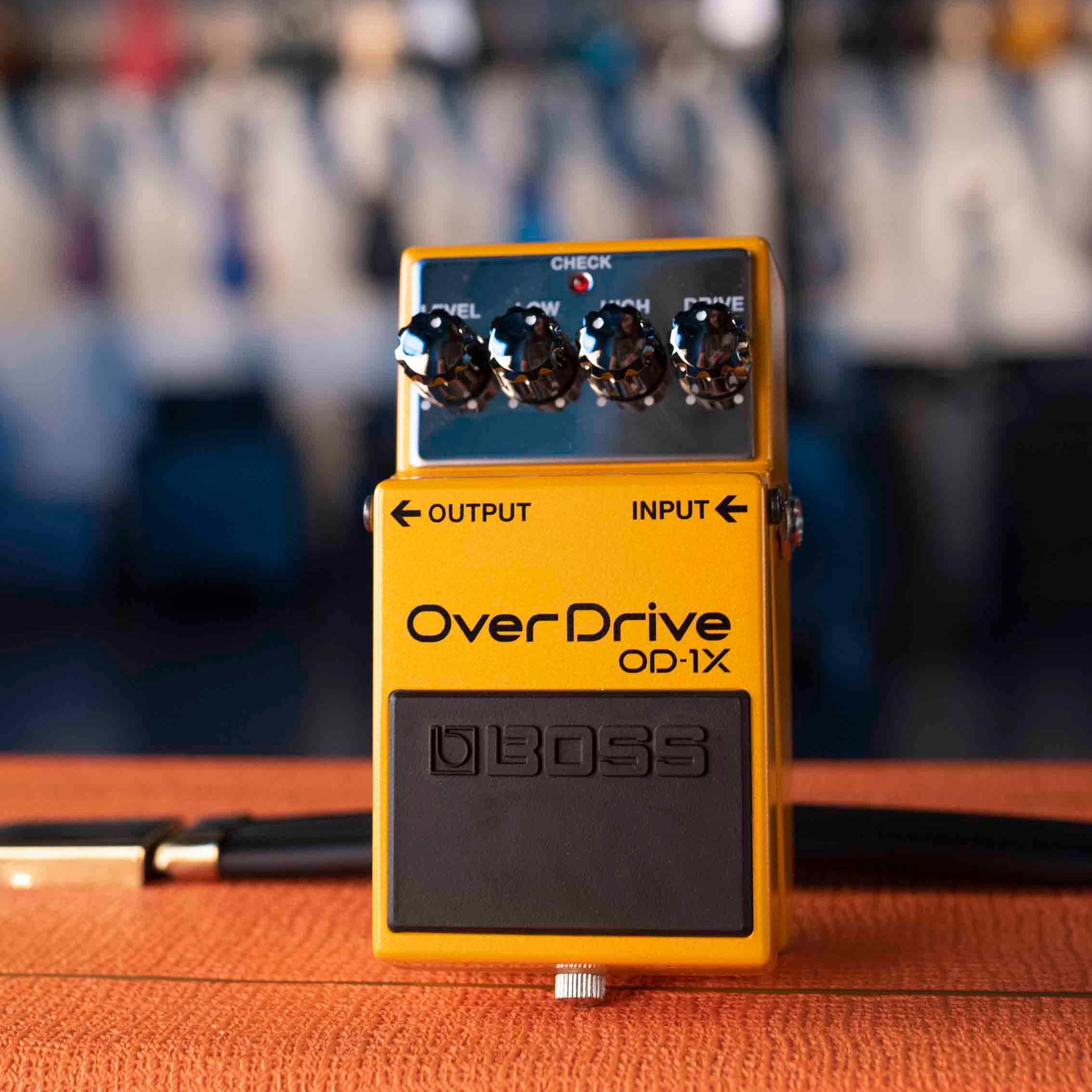 Yellow guitar effects pedal with four black knobs and input and output jacks labeled OverDrive OD-1X.