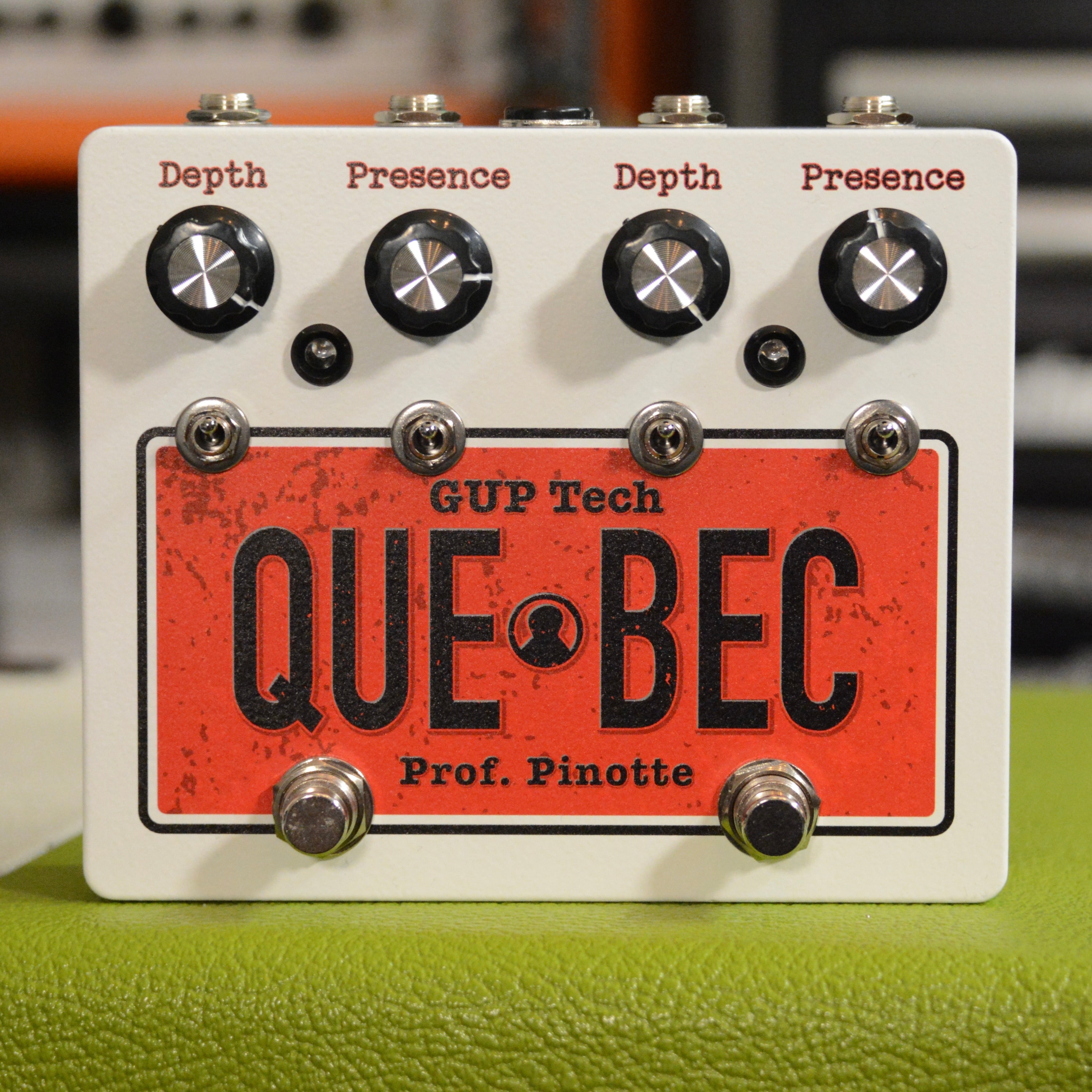 White and red guitar effects pedal with knobs labeled Depth and Presence, toggle switches, and footswitches.