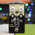 Black guitar effects pedal with four knobs, two toggle switches, one footswitch, and a cartoon paperclip graphic.