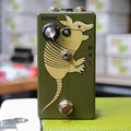 Green guitar effects pedal with armadillo graphic, one volume knob, toggle switch, and footswitch.