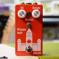 Red guitar effects pedal with two white knobs, toggle switch, footswitch, and Canada-themed design.