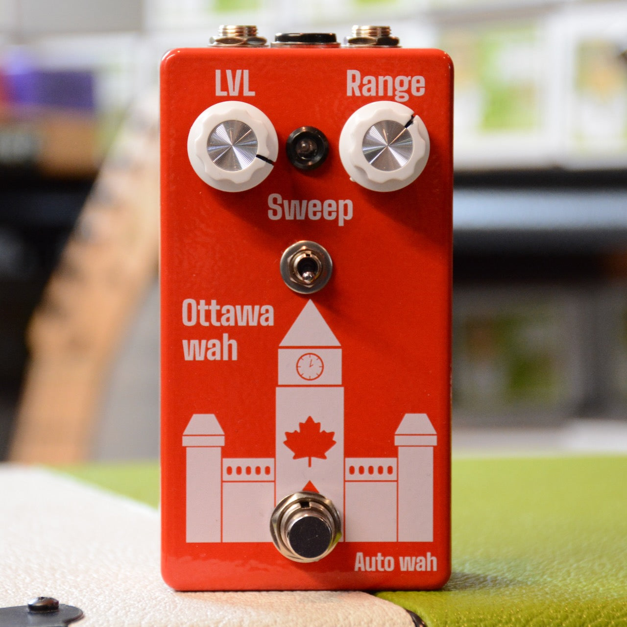 Red guitar effects pedal with two white knobs, toggle switch, footswitch, and Canada-themed design.