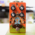 Orange guitar effects pedal with cartoon turkey graphic, four control knobs, a toggle switch, and a footswitch.