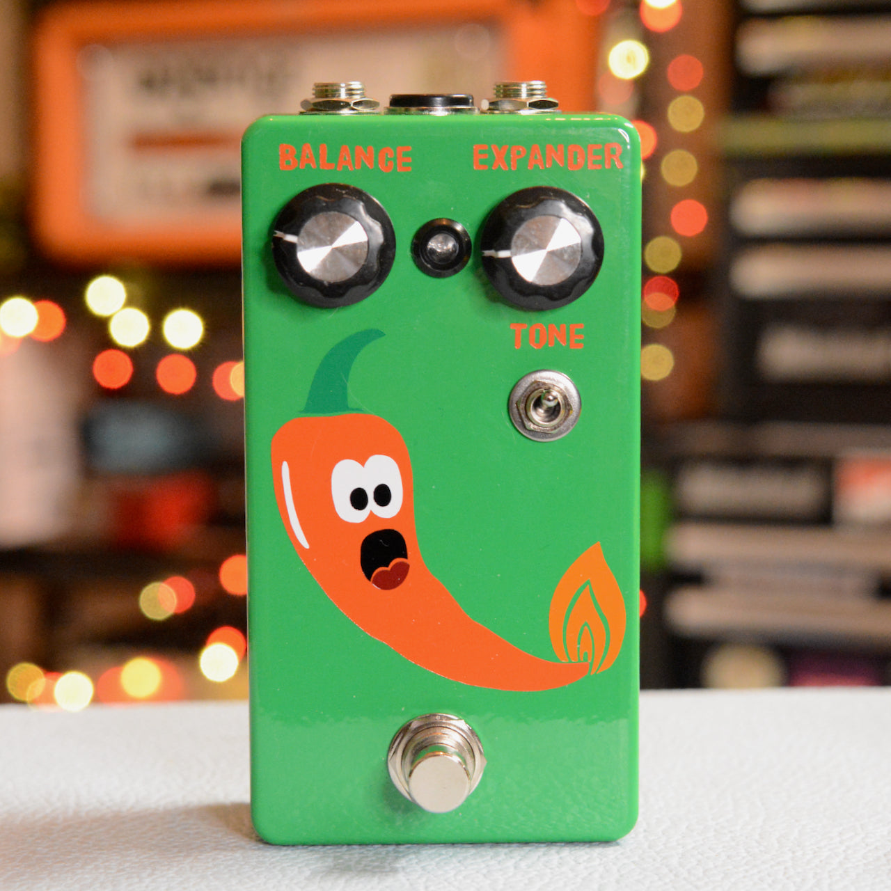 Green effects pedal with orange chili pepper graphic and knobs labeled Balance, Expander, and Tone.