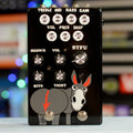 Black guitar effects pedal with multiple control knobs and two footswitches featuring a cartoon donkey graphic.