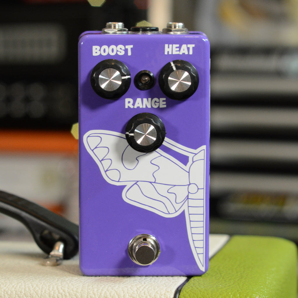 Purple guitar effects pedal with three knobs labeled Boost, Heat, and Range, a footswitch, and butterfly graphic.