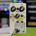 White guitar effects pedal with graphical seal drawing, three control knobs, one toggle switch, and one footswitch.
