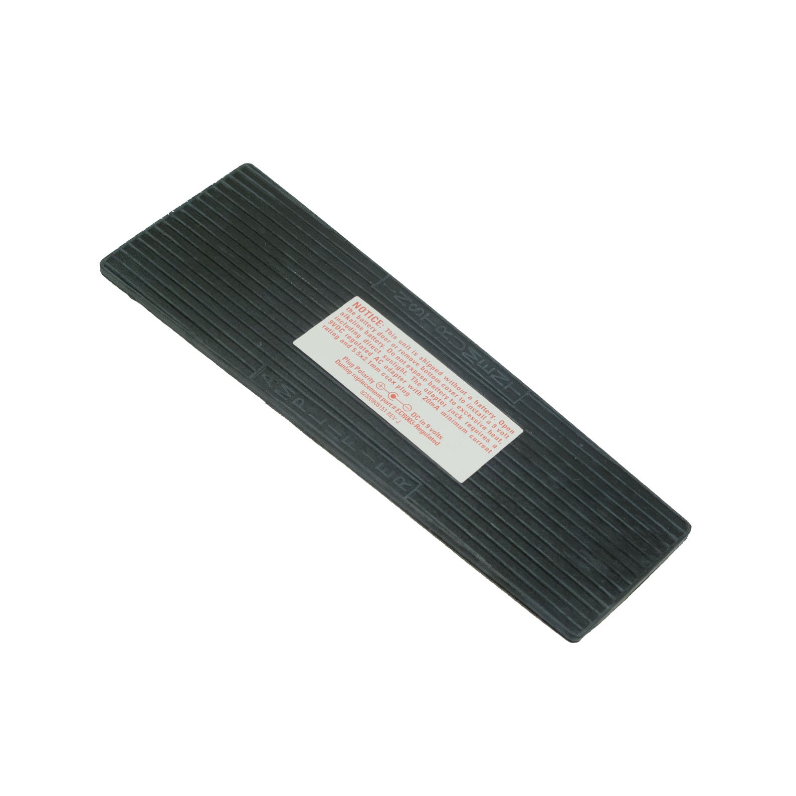Black rubber replacement tread for a pedal with a warning label attached