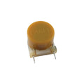 Yellow cylindrical electronic component with two metal wire leads and white base marked FASEL.