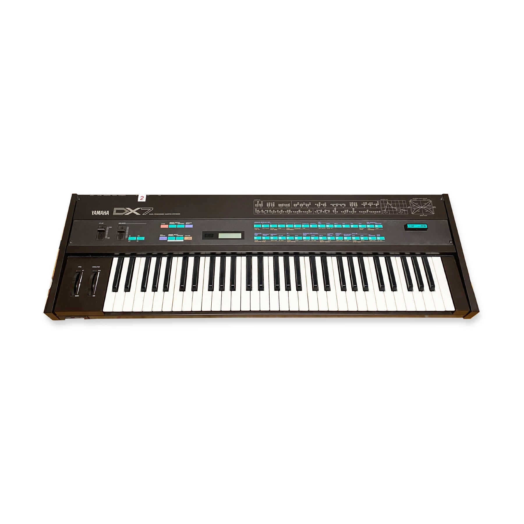 Black Yamaha DX7 programmable algorithm synthesizer keyboard with modulation and pitch wheels and multiple buttons.