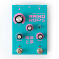 A turquoise and pink guitar effect pedal with multiple knobs, two footswitches, and audio input/output jacks.