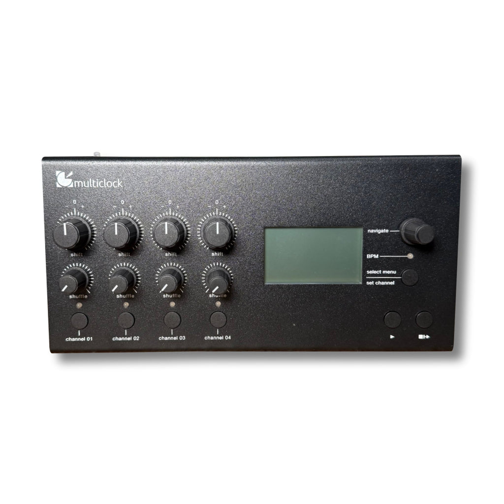 Black electronic device with multiple rotary knobs, buttons, a display screen, and navigation controls on front panel.