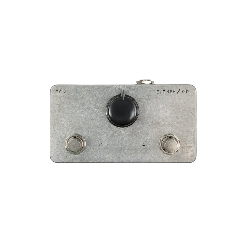 Silver rectangular metal pedal with two footswitches, one central knob, and one 1/4 inch jack on top.