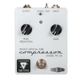 White pedal with two black knobs labeled Peak Reduction and Gain, one toggle switch, footswitch, and input/output jacks.
