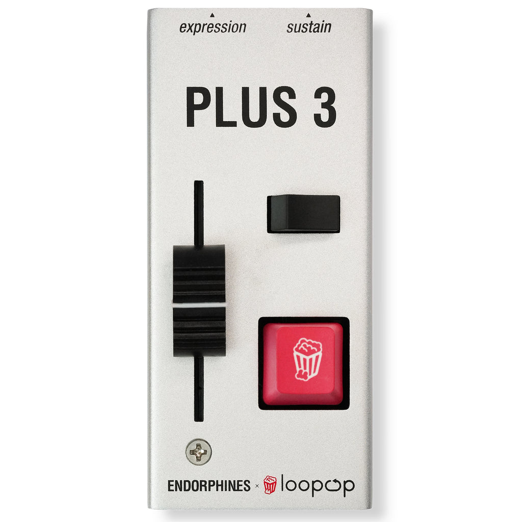 White rectangular device labeled PLUS 3 with a black slider, a small black switch, and a red push button with popcorn icon.