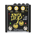 Black guitar effects pedal with three yellow rotary knobs, two footswitches, and eye illustrations on the faceplate.