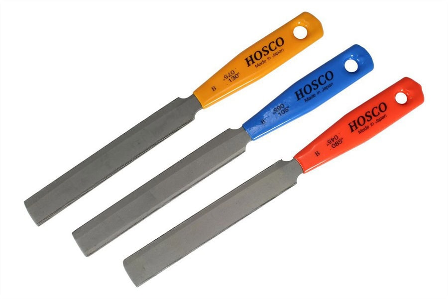 Three metal files with colored plastic handles labeled Hosco and size markings, arranged on a white background.