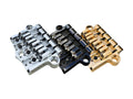 Three metal guitar bridge pieces in silver, black, and gold finishes with adjustment screws.
