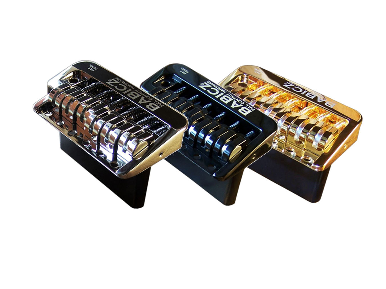 Three Babicz FCH Strat narrow tremolo bridges in silver, black, and gold finishes shown side by side.