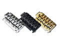 Three Babicz guitar bridges in silver, black, and gold, shown side by side.