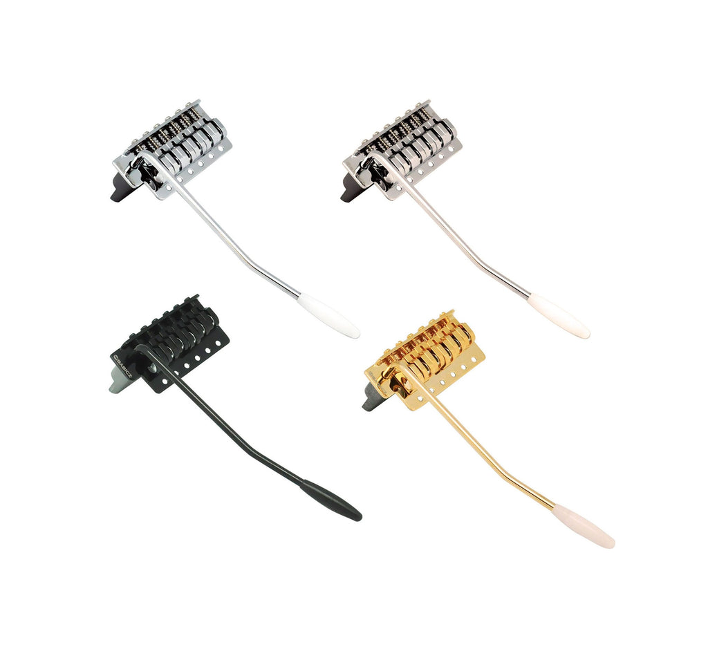 Four narrow guitar tremolo bridge units in silver, black, and gold finishes with attached whammy bars.