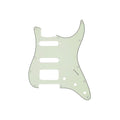 Light green guitar pickguard with multiple pickup and control holes on white background.