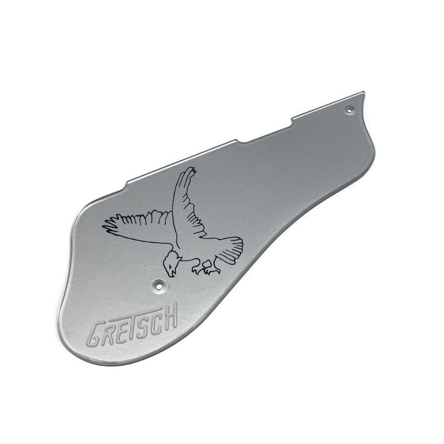 Silver metal guitar pickguard with an engraved eagle and the word GRETSCH.
