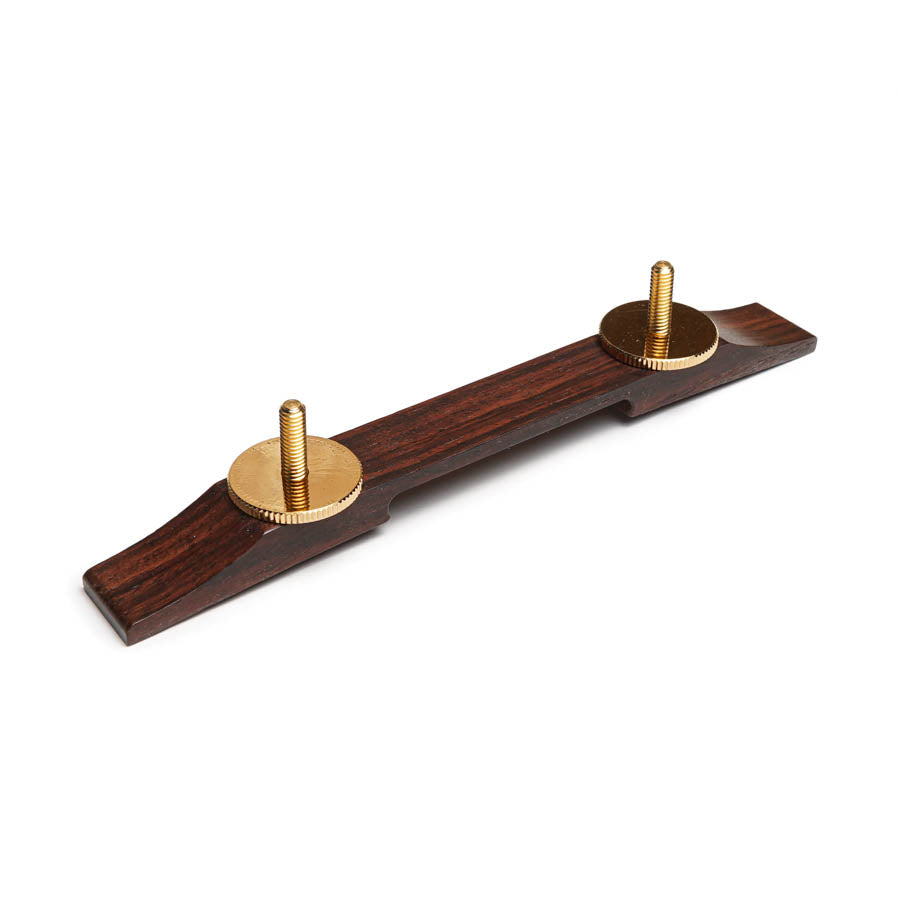 Rosewood guitar bridge piece with two gold thumb screws attached.