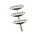 Three white single-coil guitar pickups with black pole pieces and attached wires on a white background.