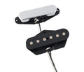 Two electric guitar pickups with black bases and wire leads, one with a silver cover and the other with visible pole pieces.