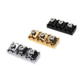 Three small metal clamps with hex screws in black, gold, and silver colors on a white background.