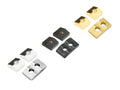 Three pairs of metal clamping blocks in silver, black, and gold colors with holes for screws.