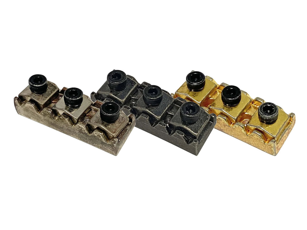 Three metal locking nut blocks in gold, black, and silver colors with hex screws on top.