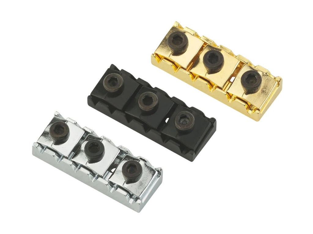 Three metal guitar string nut pieces in gold, black, and silver with hex screws on top.