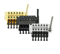 Three guitar tremolo bridge units in gold, black, and chrome finish with attached whammy bars.