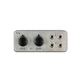 Rectangular metal device with two black knobs and four 1/4 inch jacks labeled I and O.