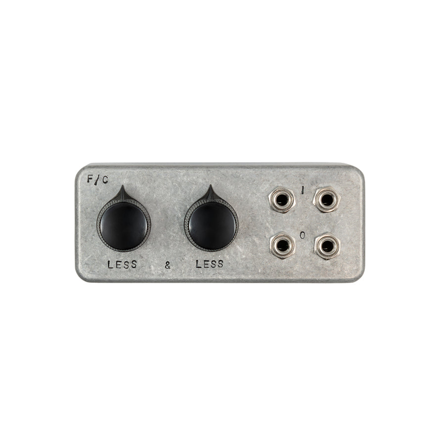 Rectangular metal device with two black knobs and four 1/4 inch jacks labeled I and O.