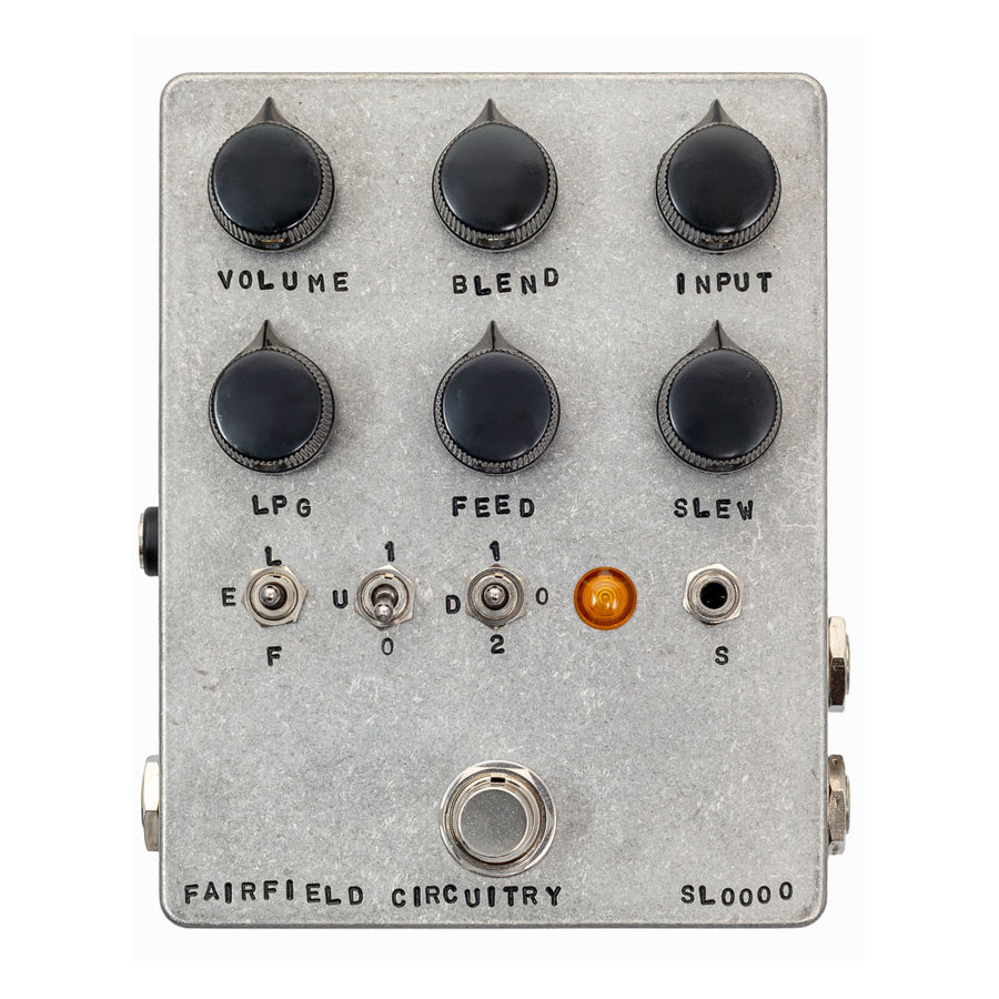 Silver rectangular guitar effects pedal with six black knobs, three toggles, one jack, one footswitch, and an orange indicator light.